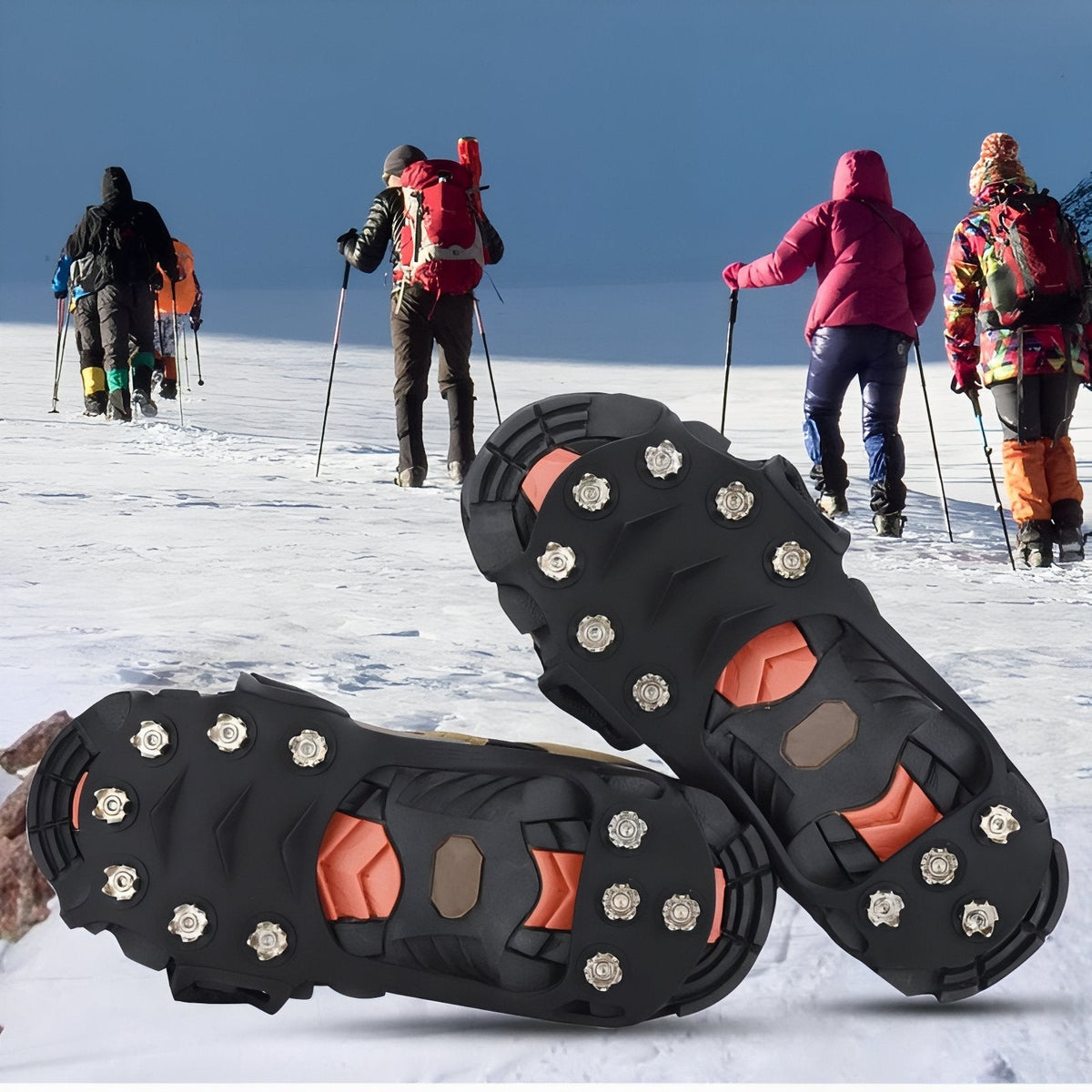 Two ice cleats on shoes on a snowy slope, with walkers and trekking poles behind