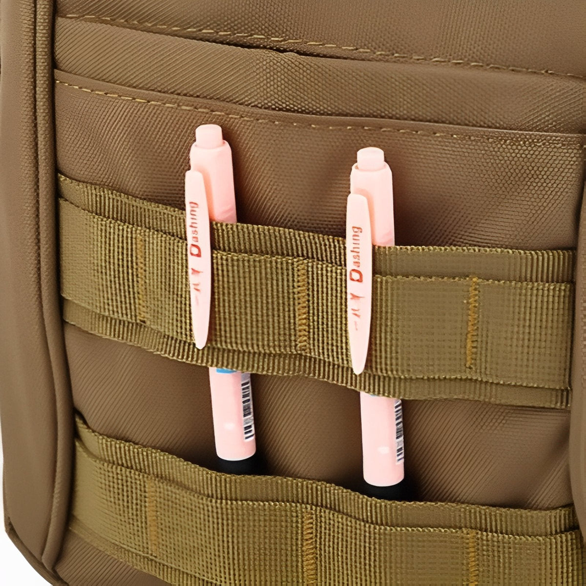 Pens tucked into the webbing on the front of the bag