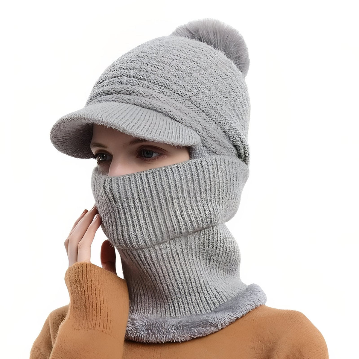 Light grey brim beanie with a grey pompom and the neck warmer pulled up