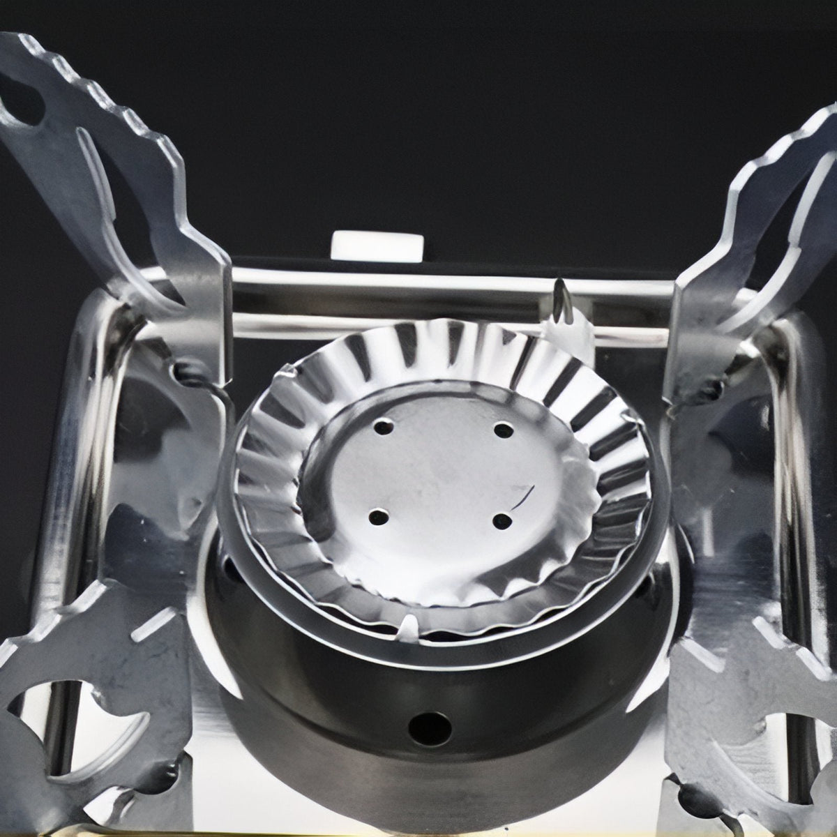 Close-up of the fluted stainless burner between the pot supports
