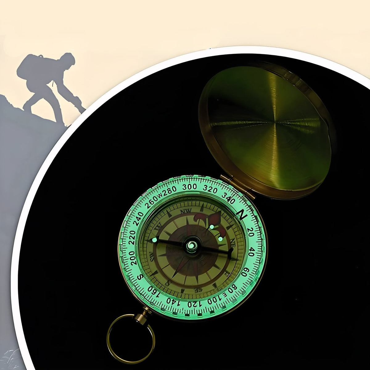 The compass in the dark with its bezel and needle glowing green
