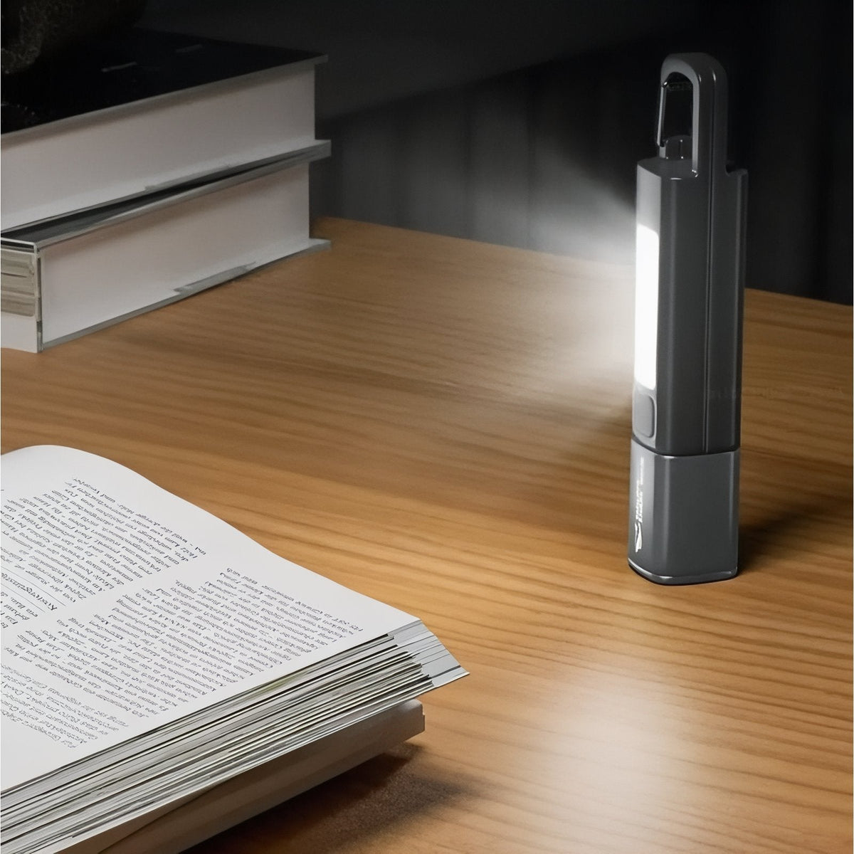 The torch standing on a desk with its side light lighting a book