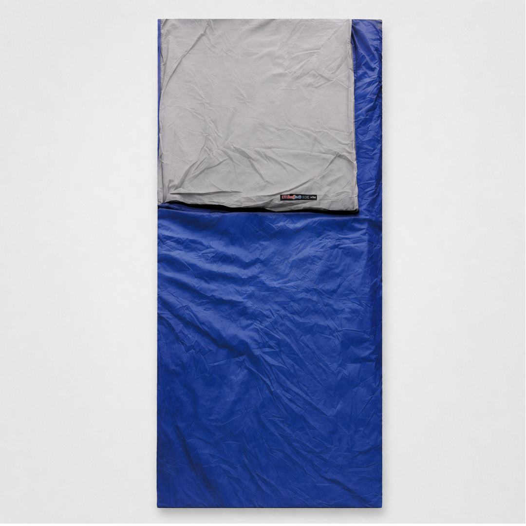 A royal blue envelope sleeping bag laid flat, its pale grey lining folded back at the head