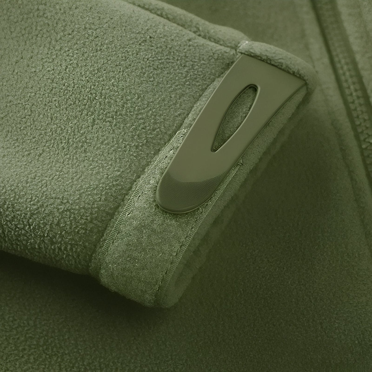 Close-up of the hook-and-loop cuff tab on the olive green fleece sleeve