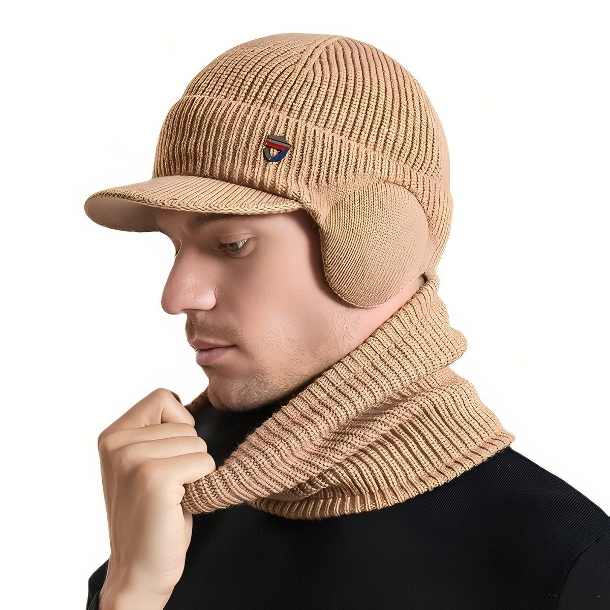 Man wearing the camel knit winter hat with brim and ear flaps and the matching neck warmer, side view