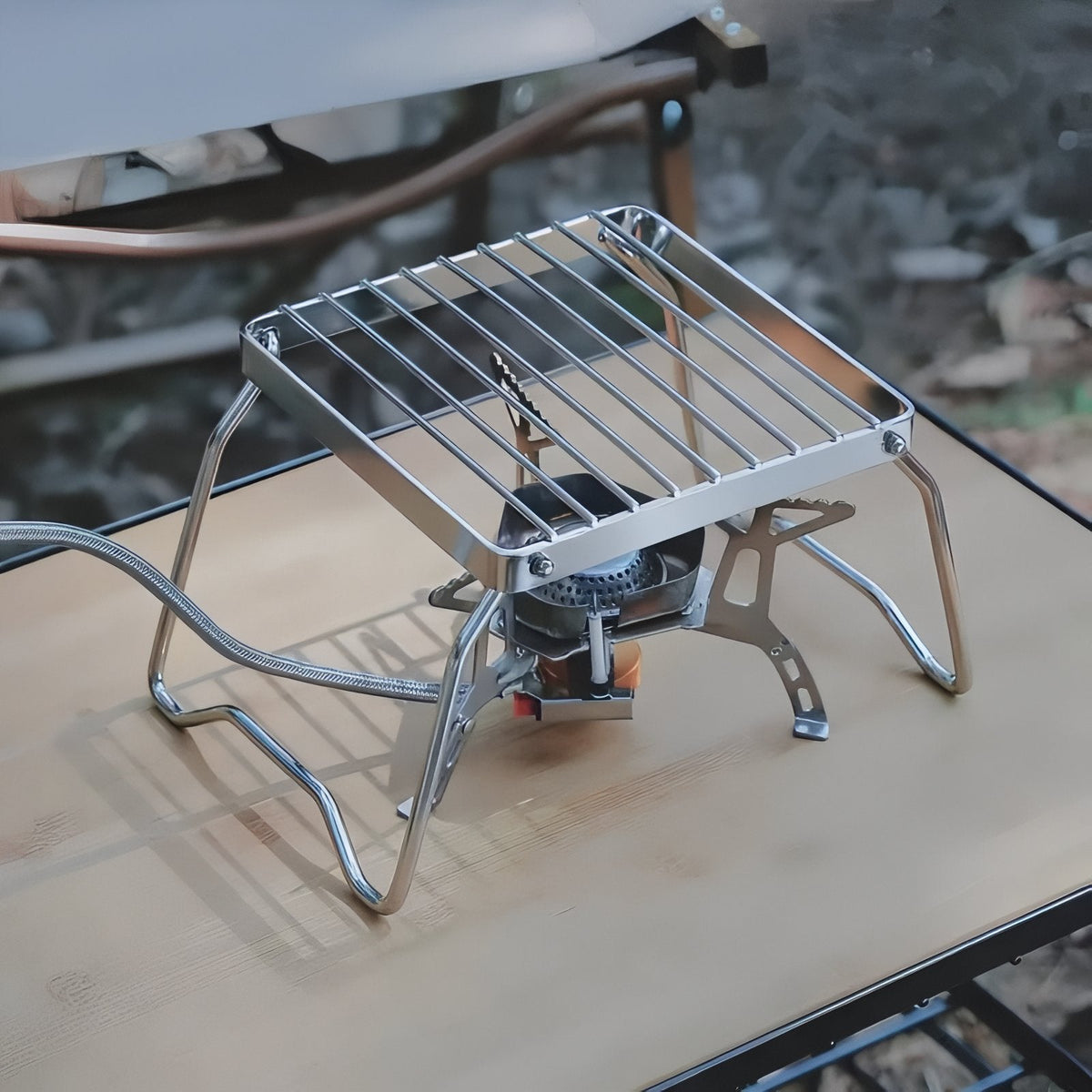 The grill stand over a gas stove on a camp table