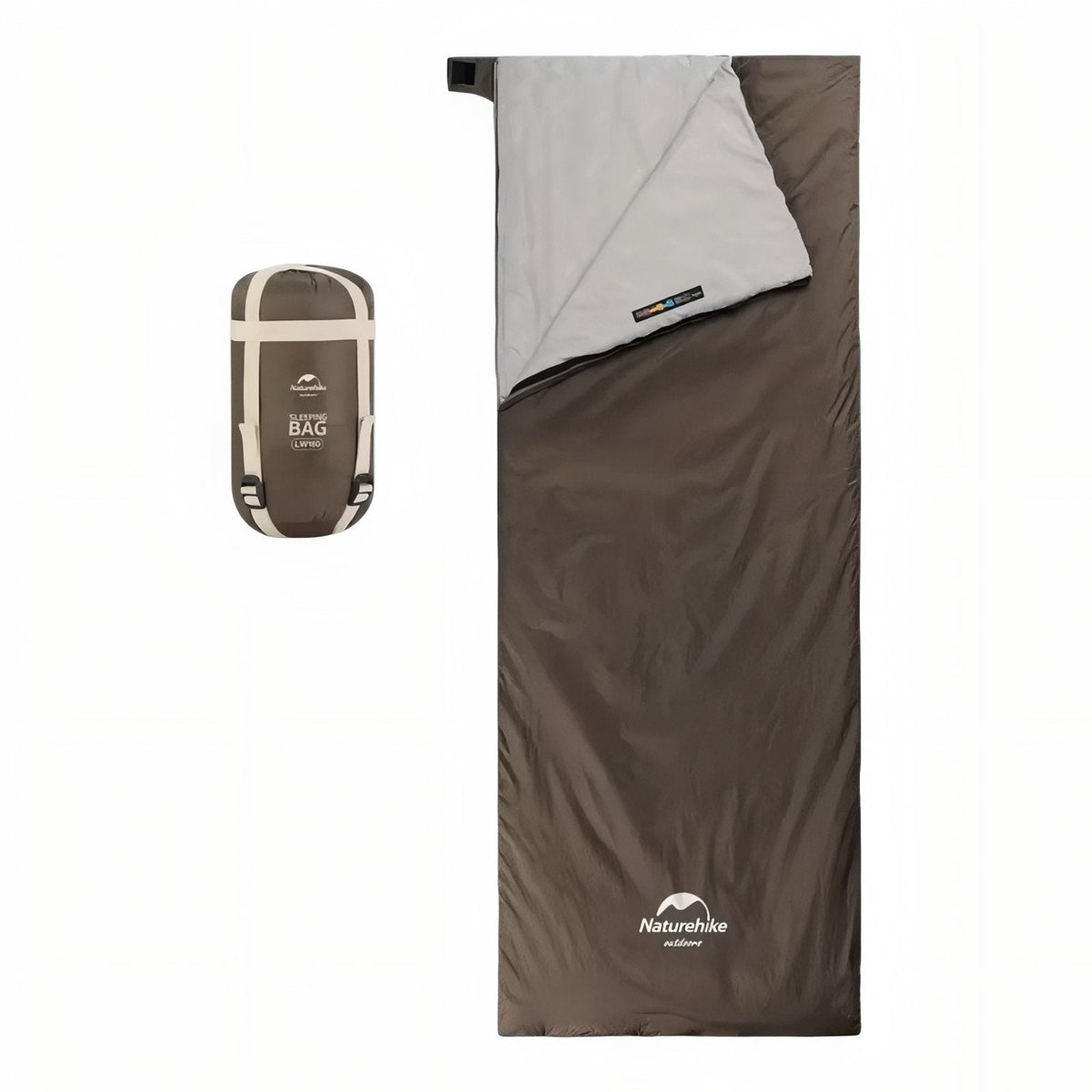 Brown envelope sleeping bag laid flat with its light grey lining folded back, beside its packed compression sack