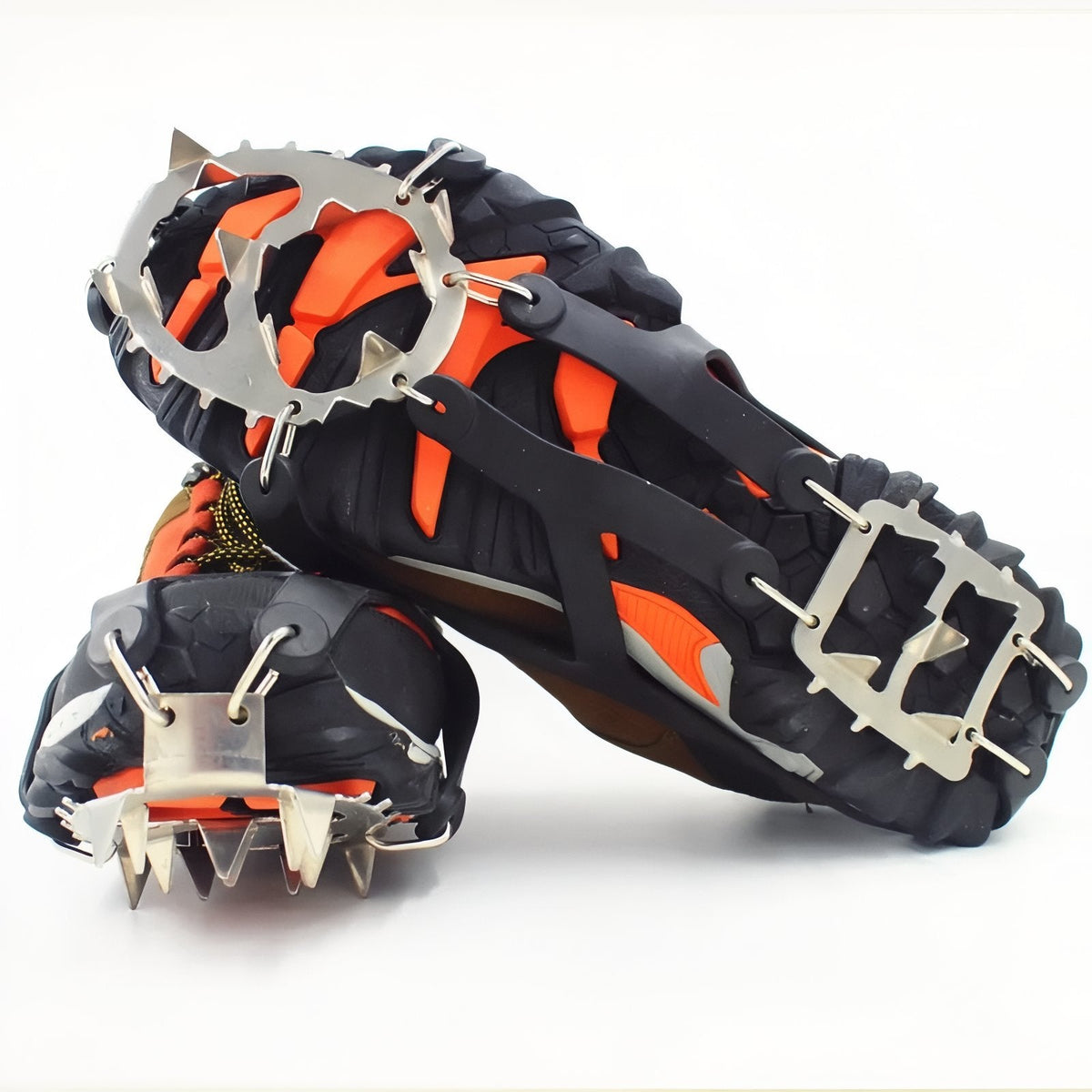 Pair of black crampons on hiking boots seen from below, stainless steel toe and heel plates with 18 spikes