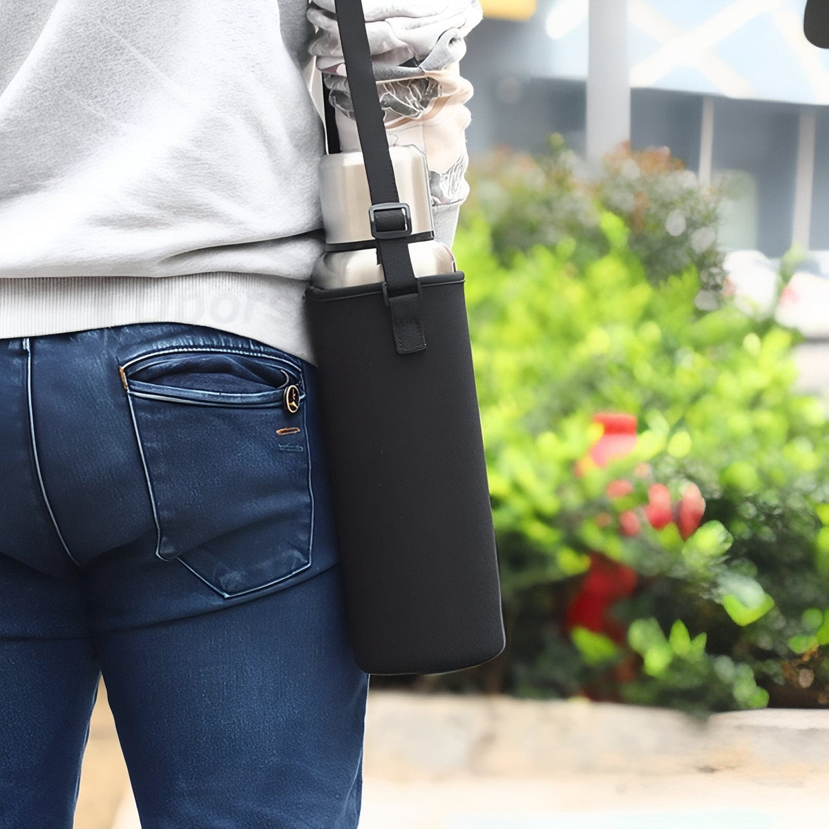 Woman carrying the flask in its black padded shoulder bag