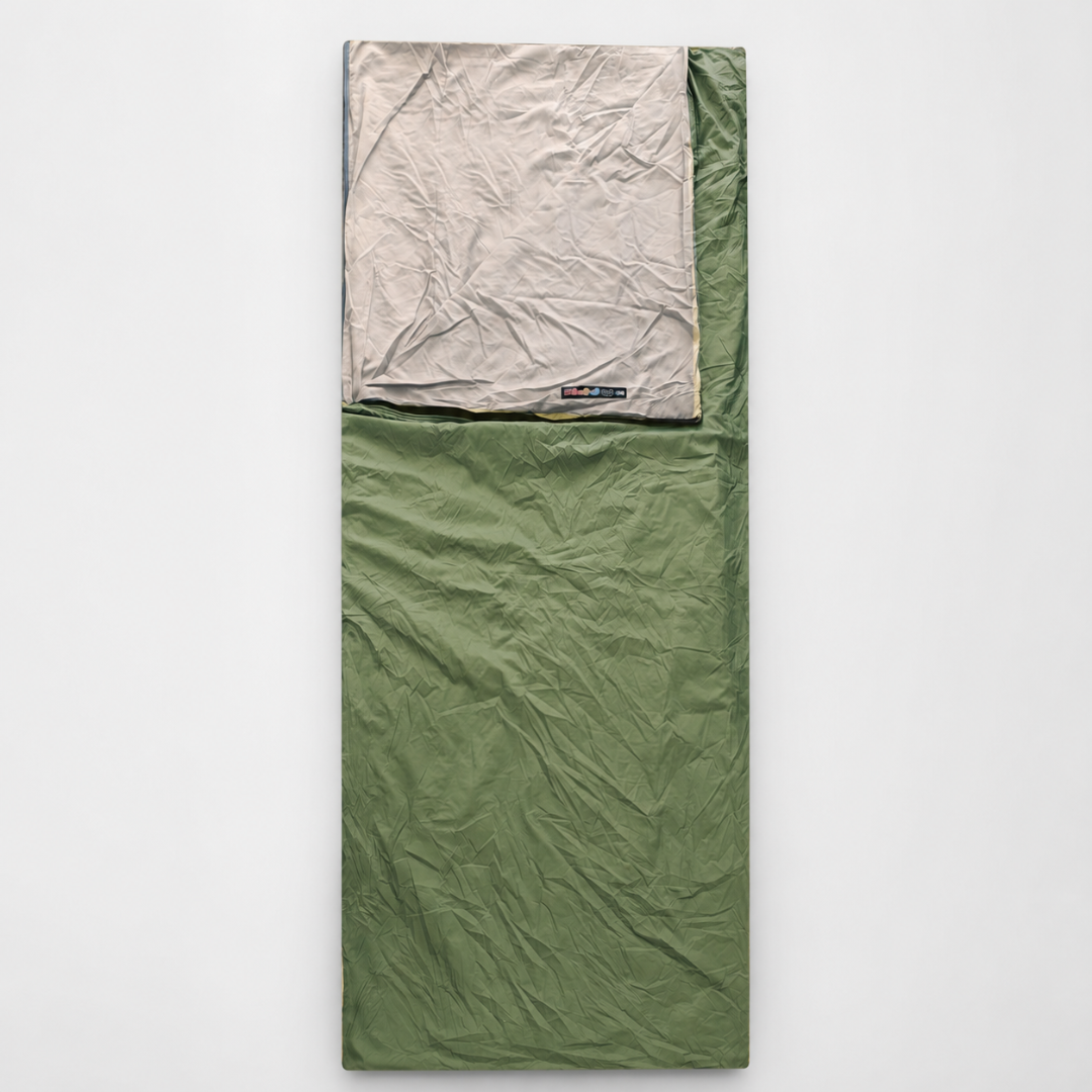 An olive green envelope sleeping bag laid flat, its beige lining folded back at the head