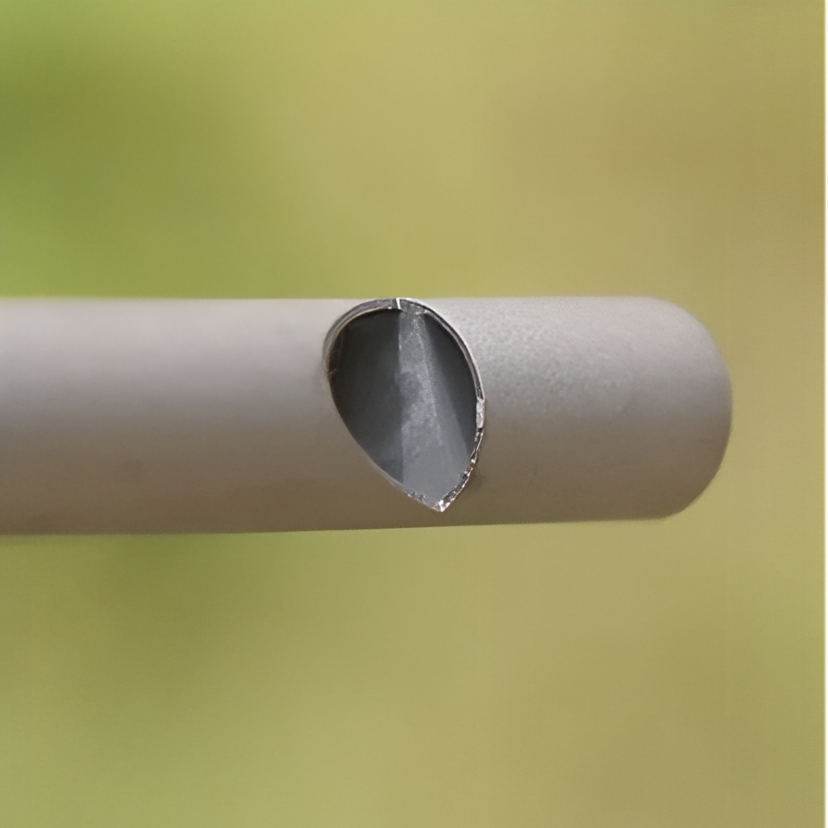 Close-up of the angled sound slot in the titanium tube