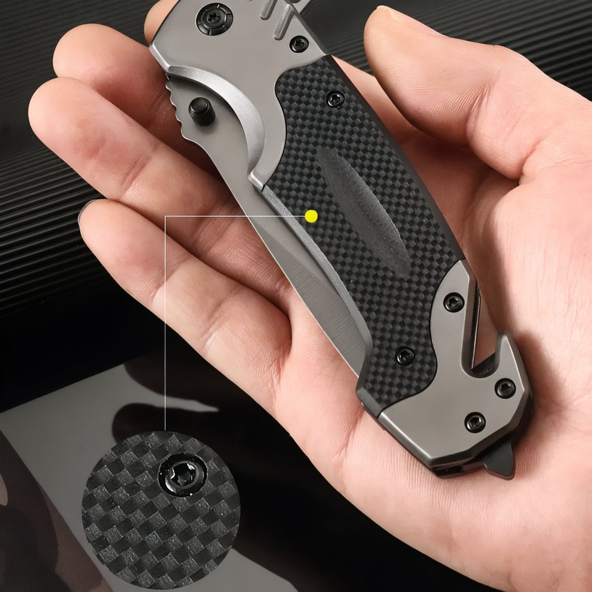 Closed folding knife in an open palm with a close-up of the textured black inlay