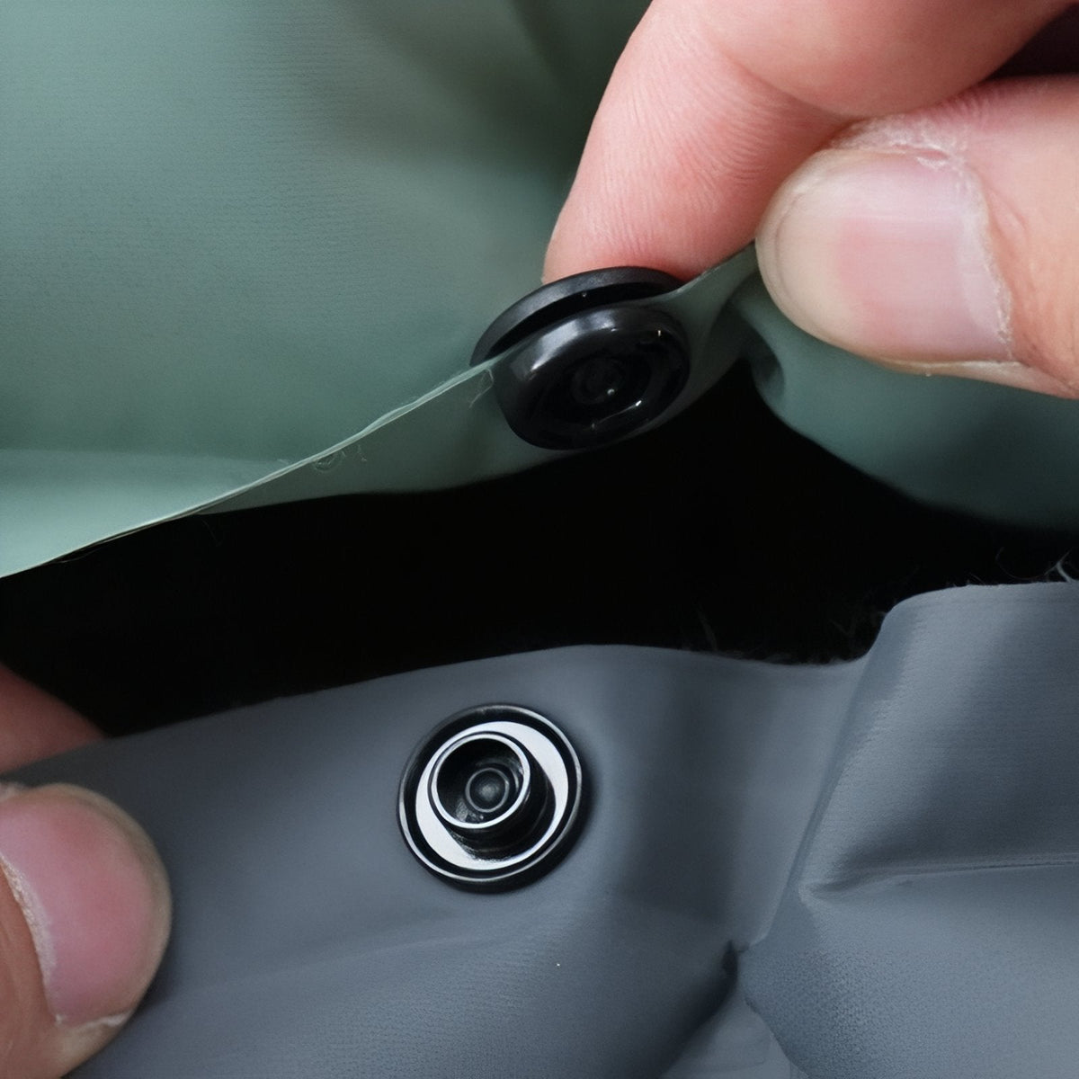 Fingers opening the mat's valve cap