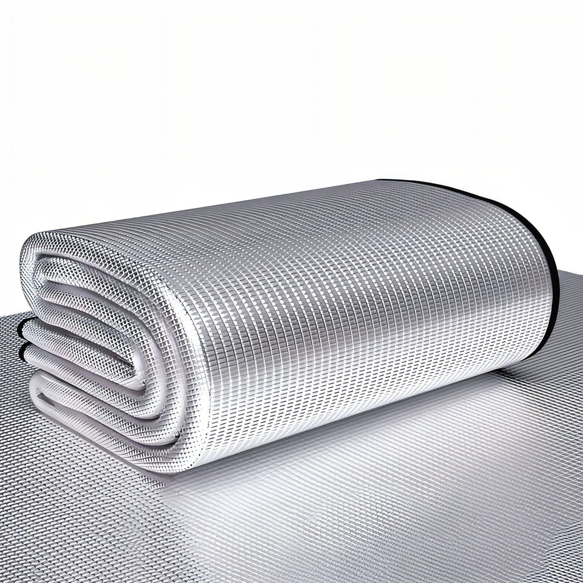 Foil foam camping mat folded in a stack, lying on a spread-out foil mat