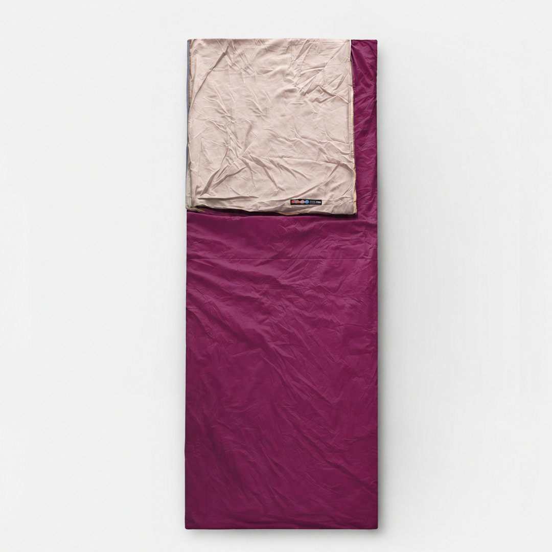 A burgundy envelope sleeping bag laid flat, its beige lining folded back at the head