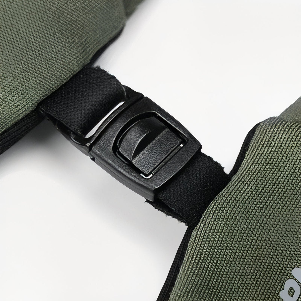 Close-up of the plastic clip on the cuff of an army green glove that joins the two gloves together