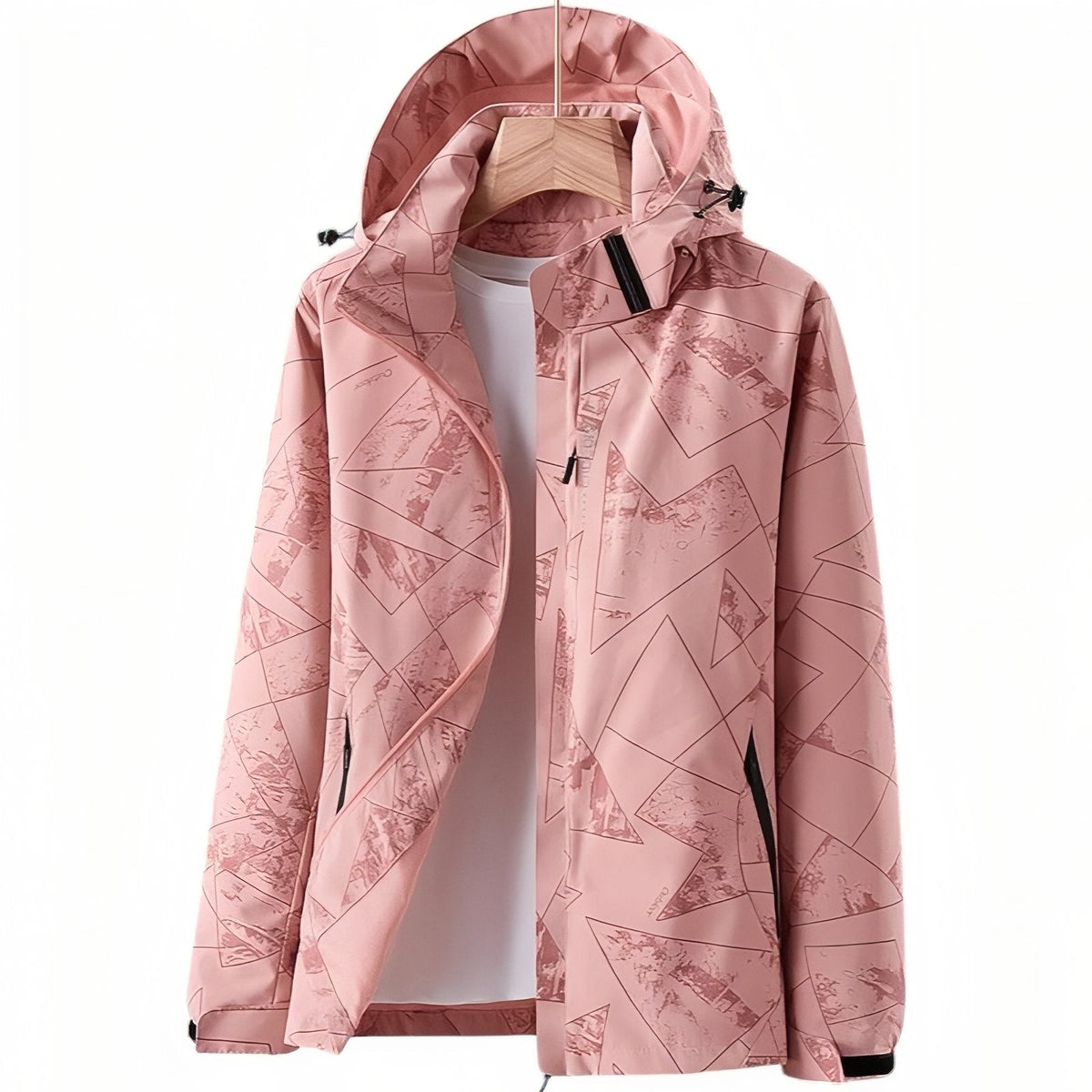 Women's pink hooded hiking jacket with a geometric line print, hanging open on a wooden hanger