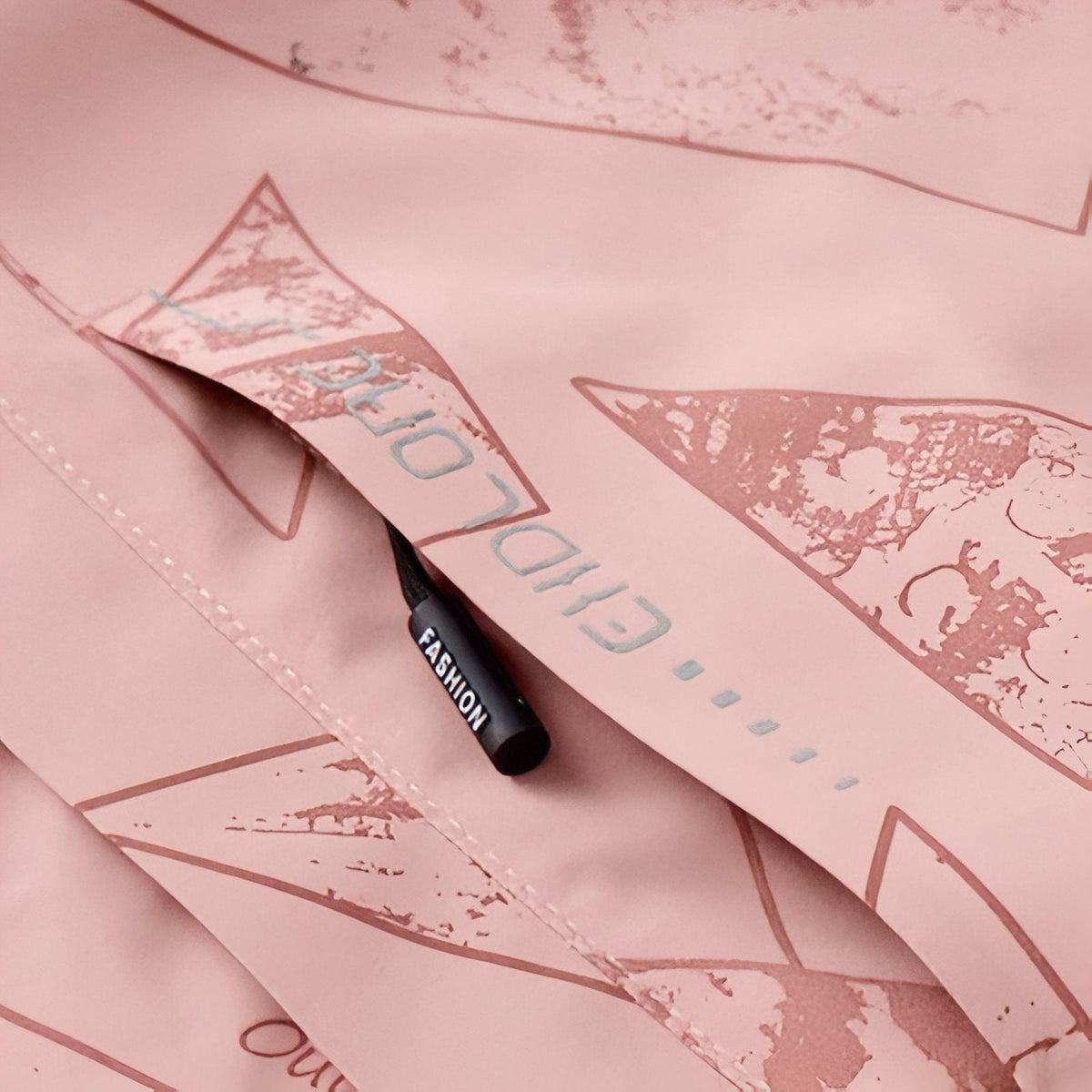 Close-up of the chest zip pocket and zip puller on the pink jacket