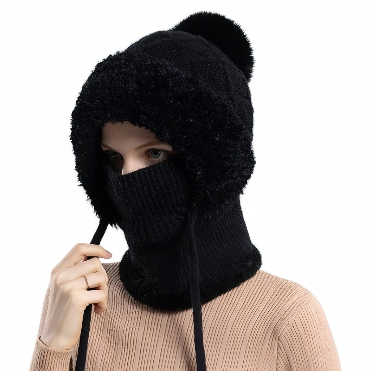 Woman wearing the black knitted balaclava hood with black faux-fur surround and pompom