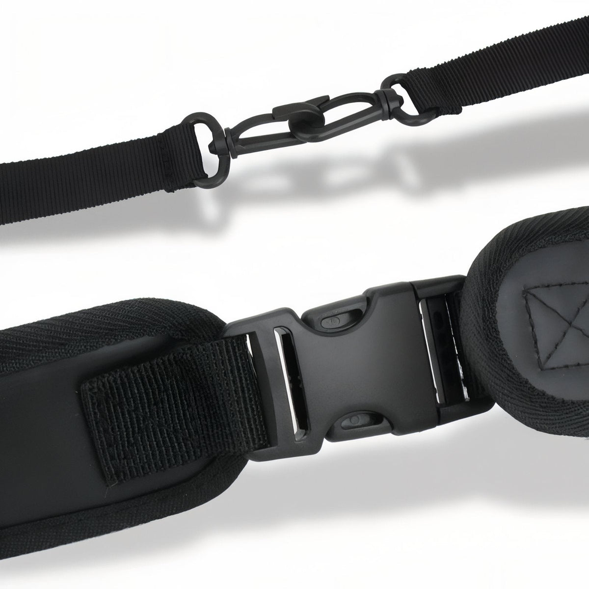 Close-up of the chest strap buckle and the padded shoulder strap