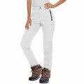 Woman wearing the white fleece-lined softshell hiking trousers with brown hiking boots, front view