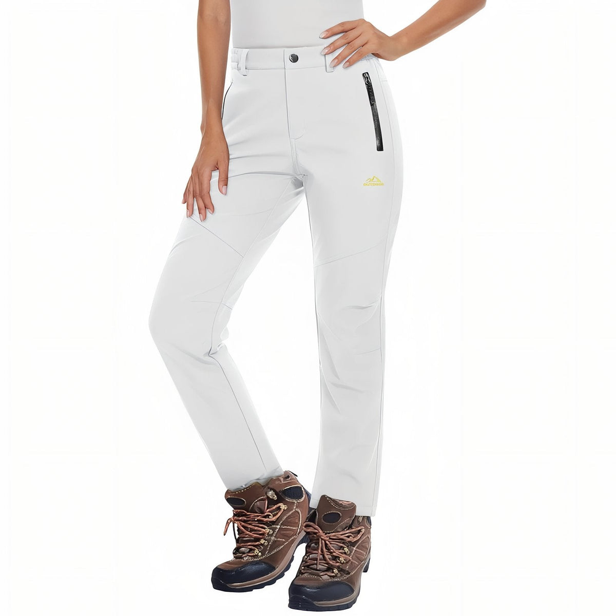 Woman wearing the white fleece-lined softshell hiking trousers with brown hiking boots, front view