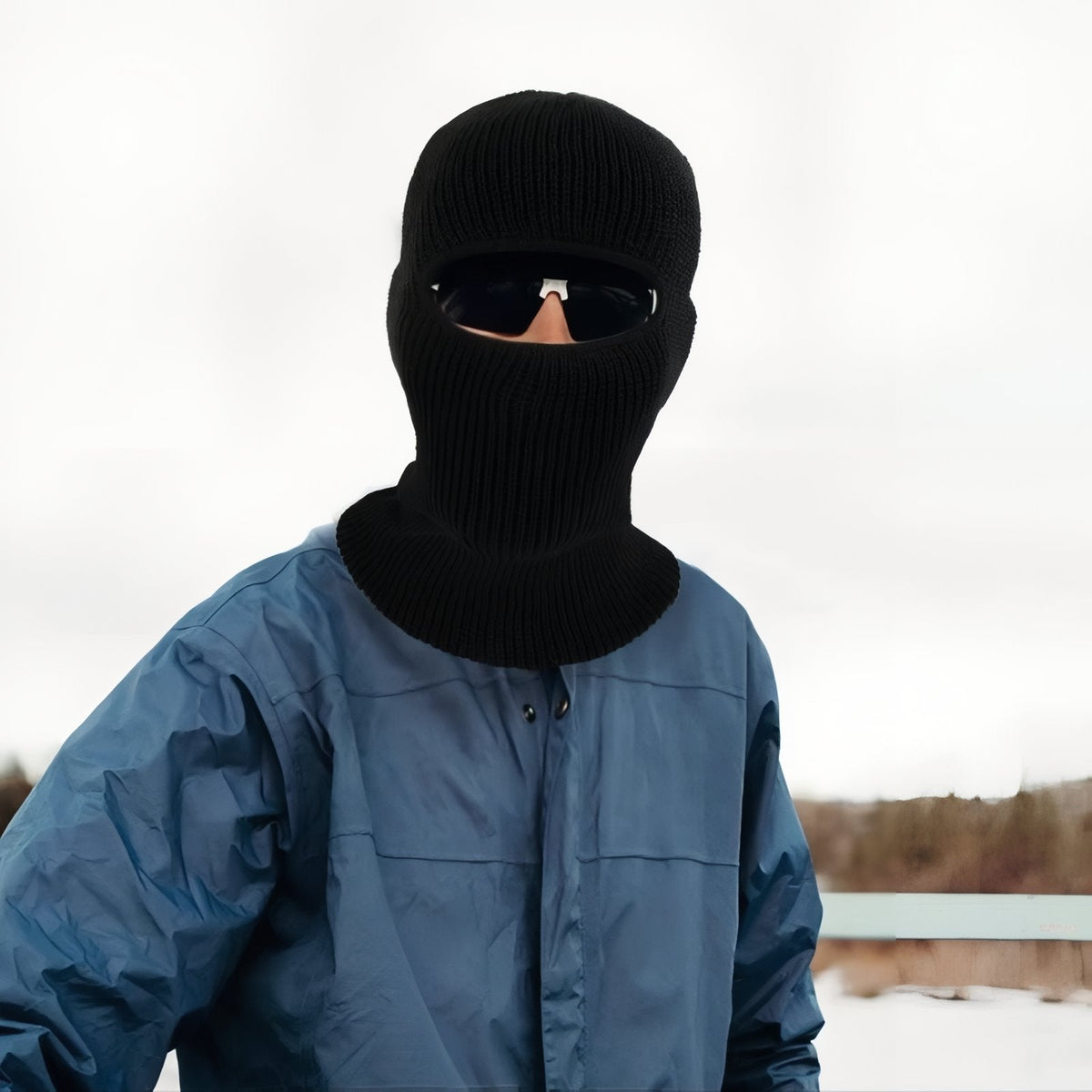 Man wearing the black knit balaclava and sunglasses outdoors in winter