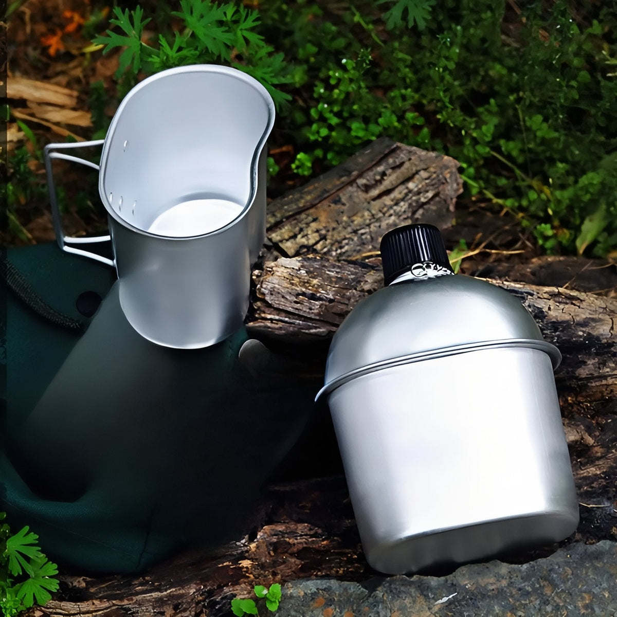 The aluminium cup and canteen on a log outdoors