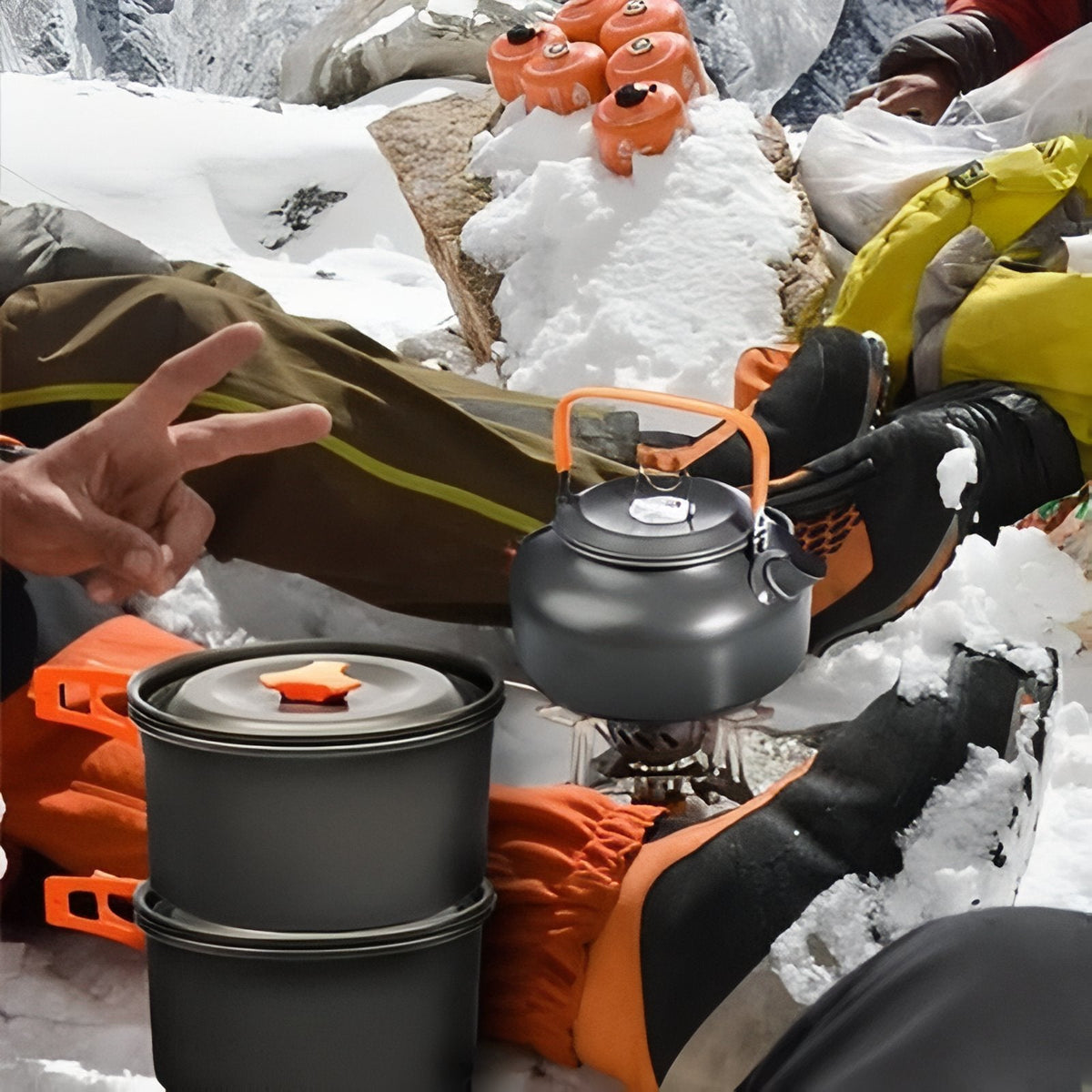 Pot and kettle in use on a camping stove in the snow