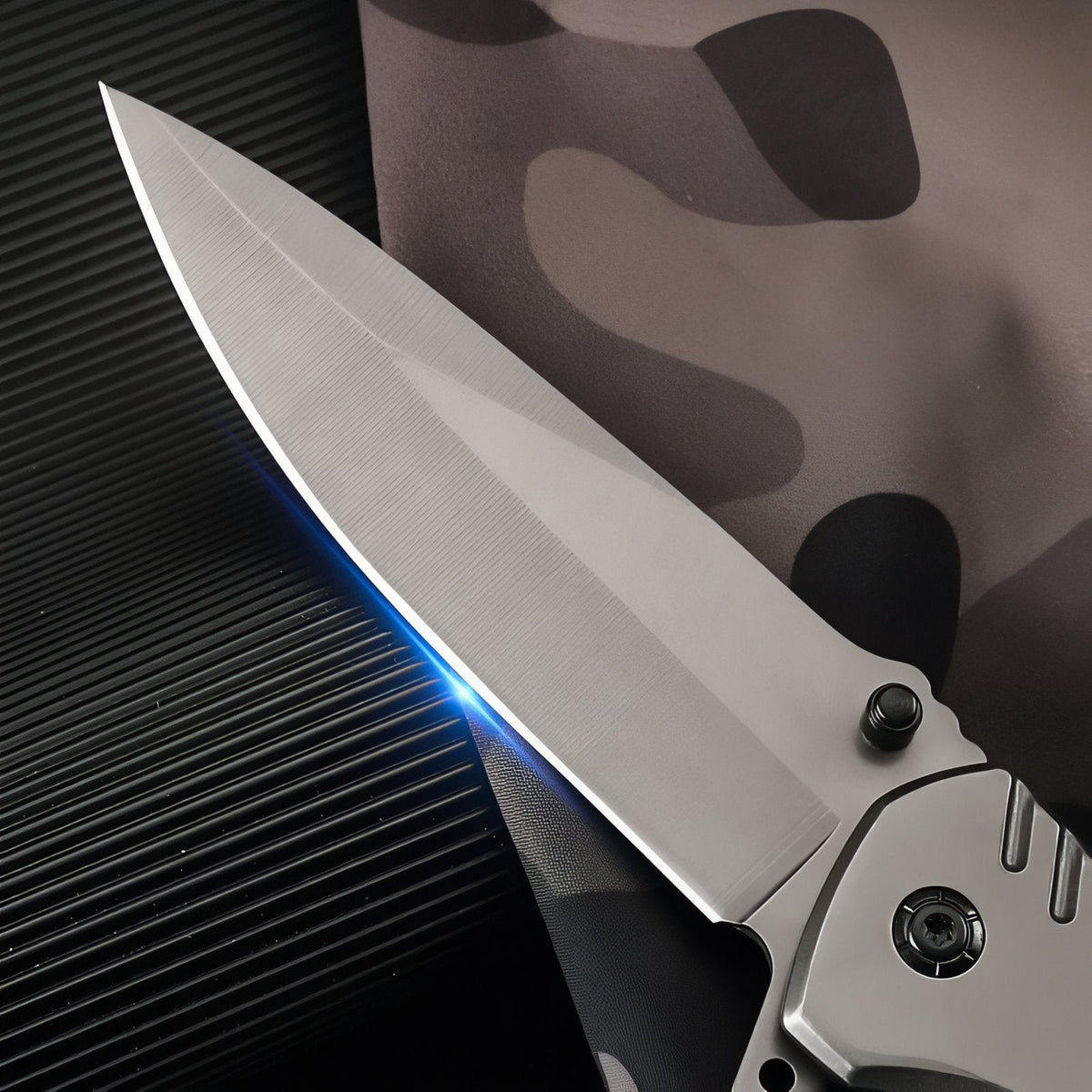 Close-up of the stainless steel drop-point blade and the pivot