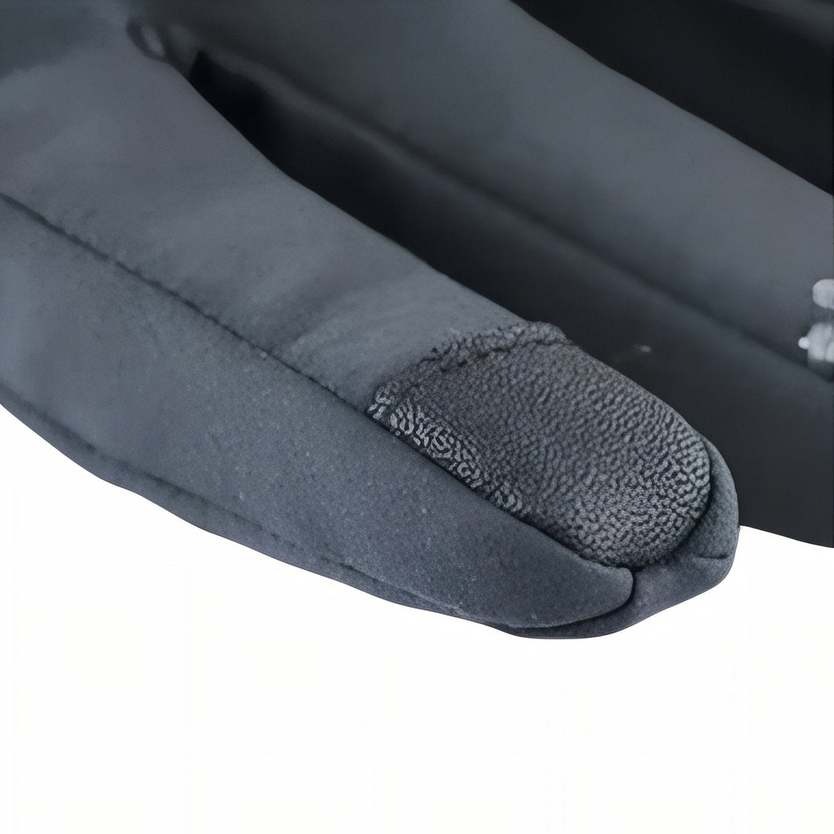 Close-up of the textured touchscreen patch on the index fingertip of a grey hiking glove