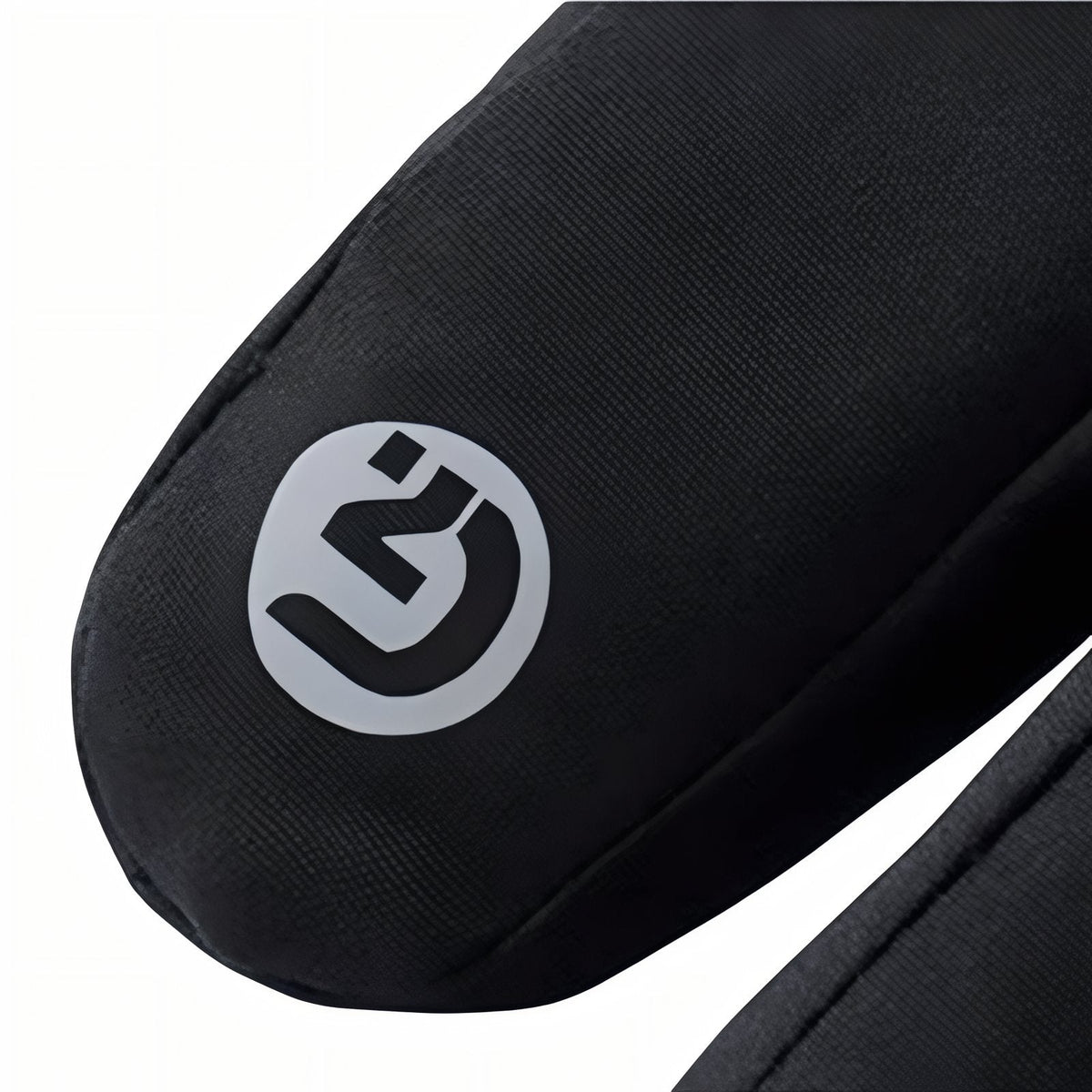 Close-up of the small round reflective badge on the fingertip of a black winter glove