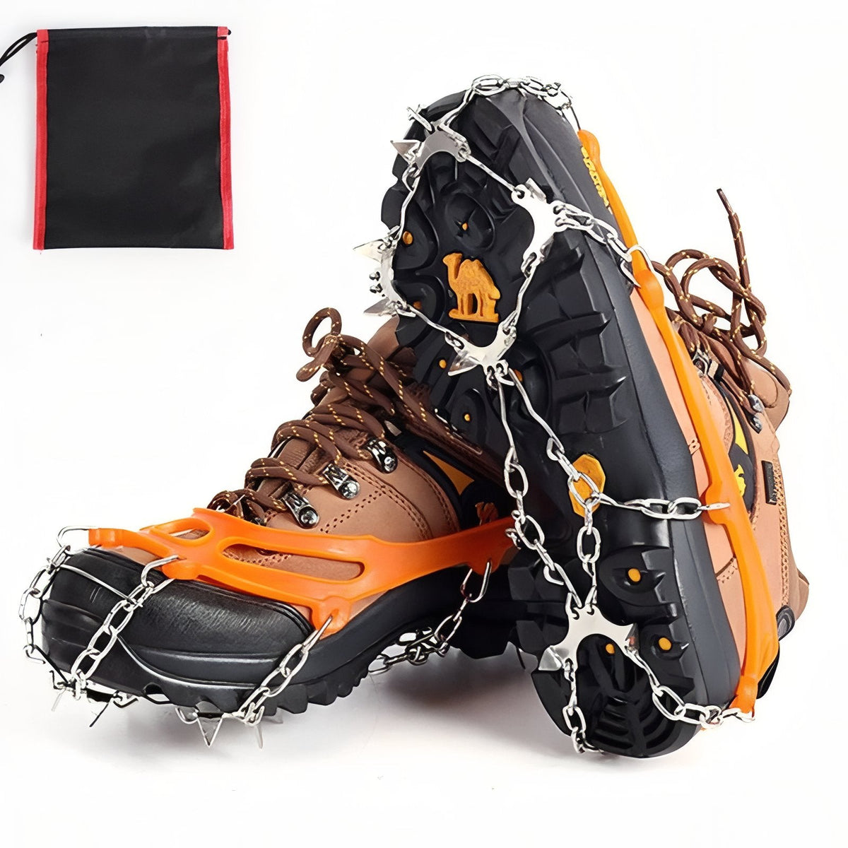 Orange chain crampons on brown hiking boots, one boot tipped up to show the chains and steel spikes under the sole, with the drawstring bag