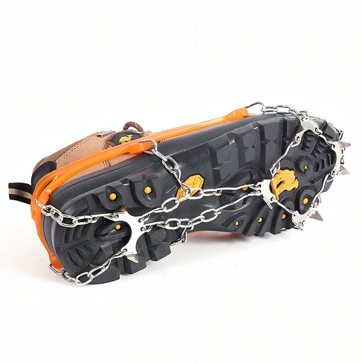 Underside of a hiking boot with the orange crampon fitted, chains and steel spikes spread across the sole