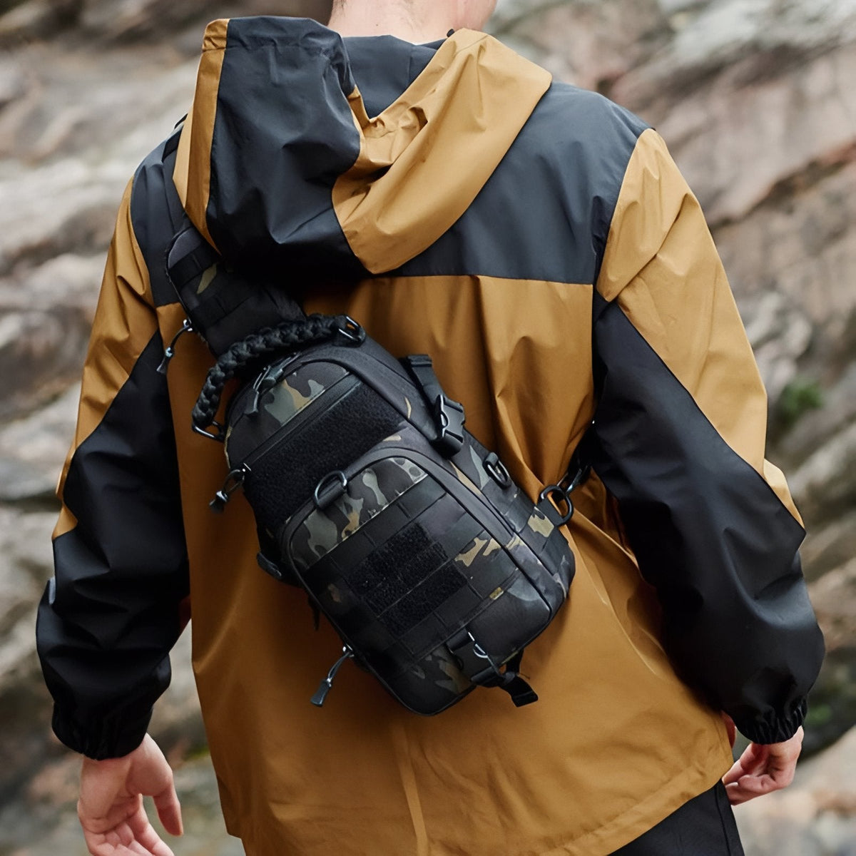 Sling bag worn across the back, seen from the side on a rocky path