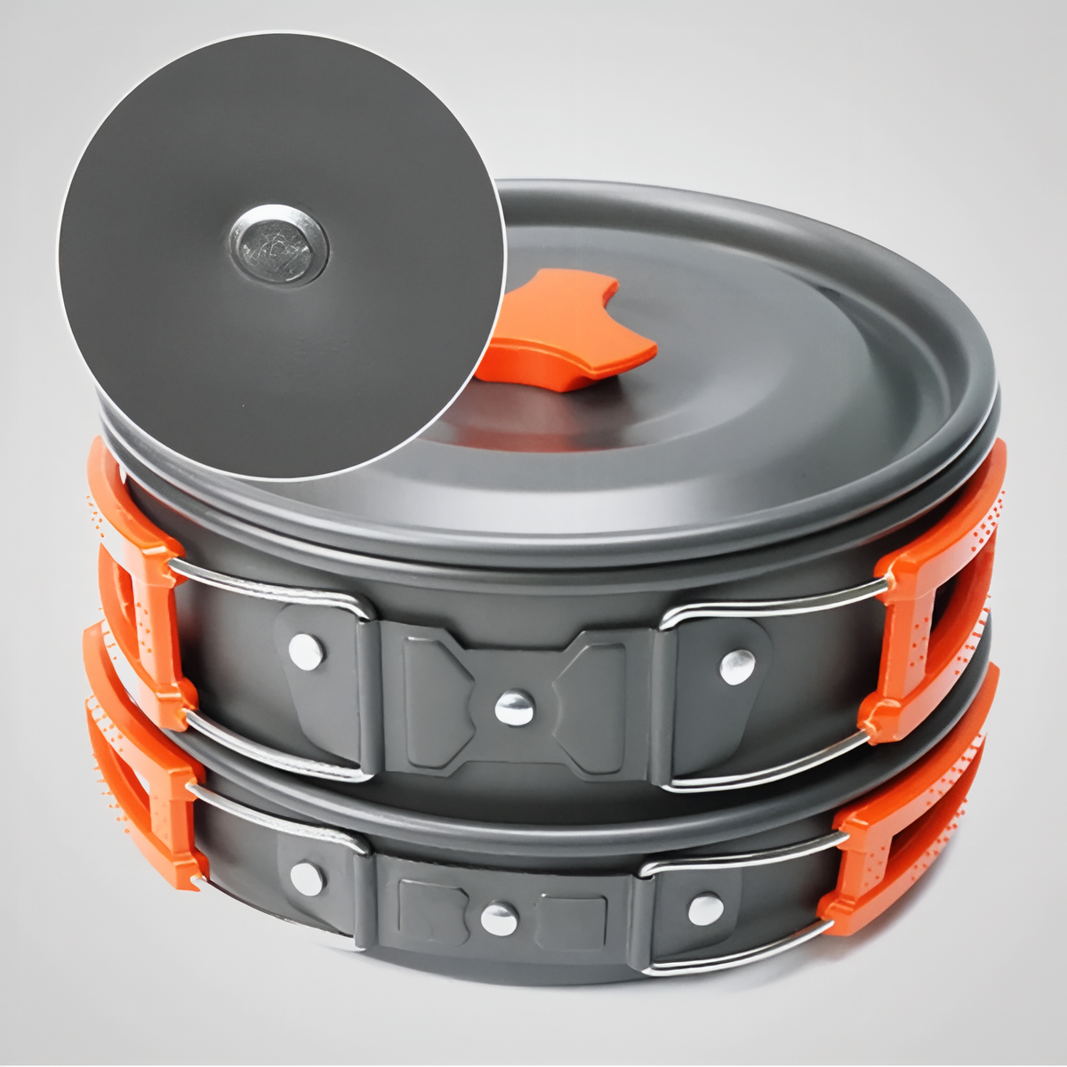 Pot and pan stacked with their orange folding handles and the lid on top