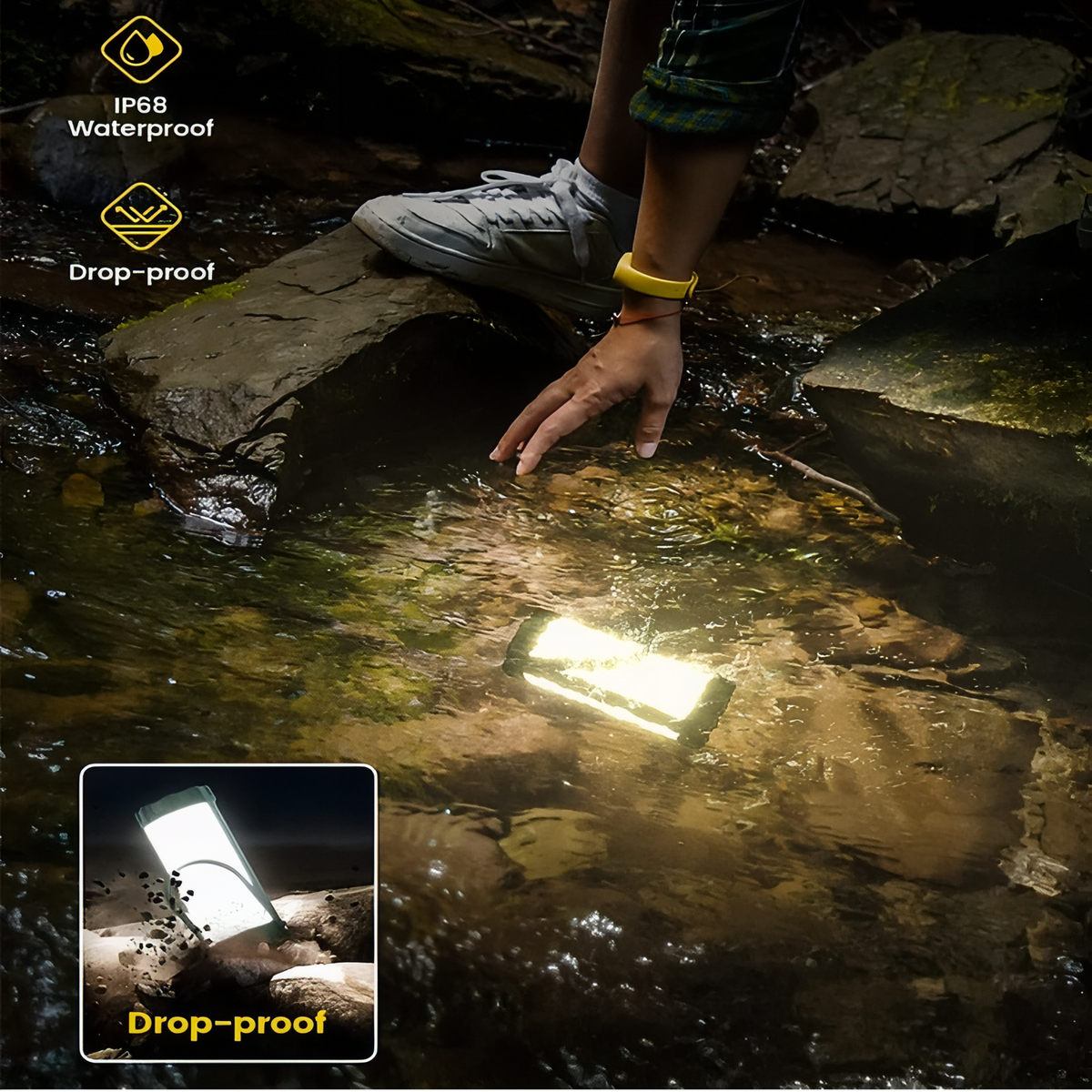 The lit lantern lying in a shallow stream among rocks, a hand reaching for it