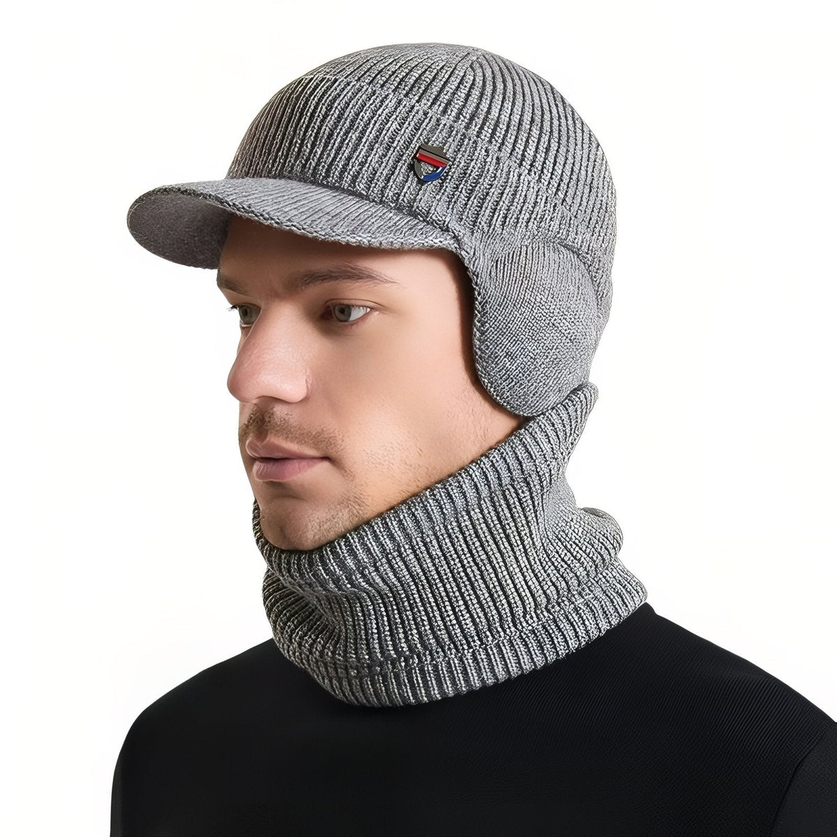 Man wearing the light grey knit winter hat with brim and ear flaps and the matching neck warmer