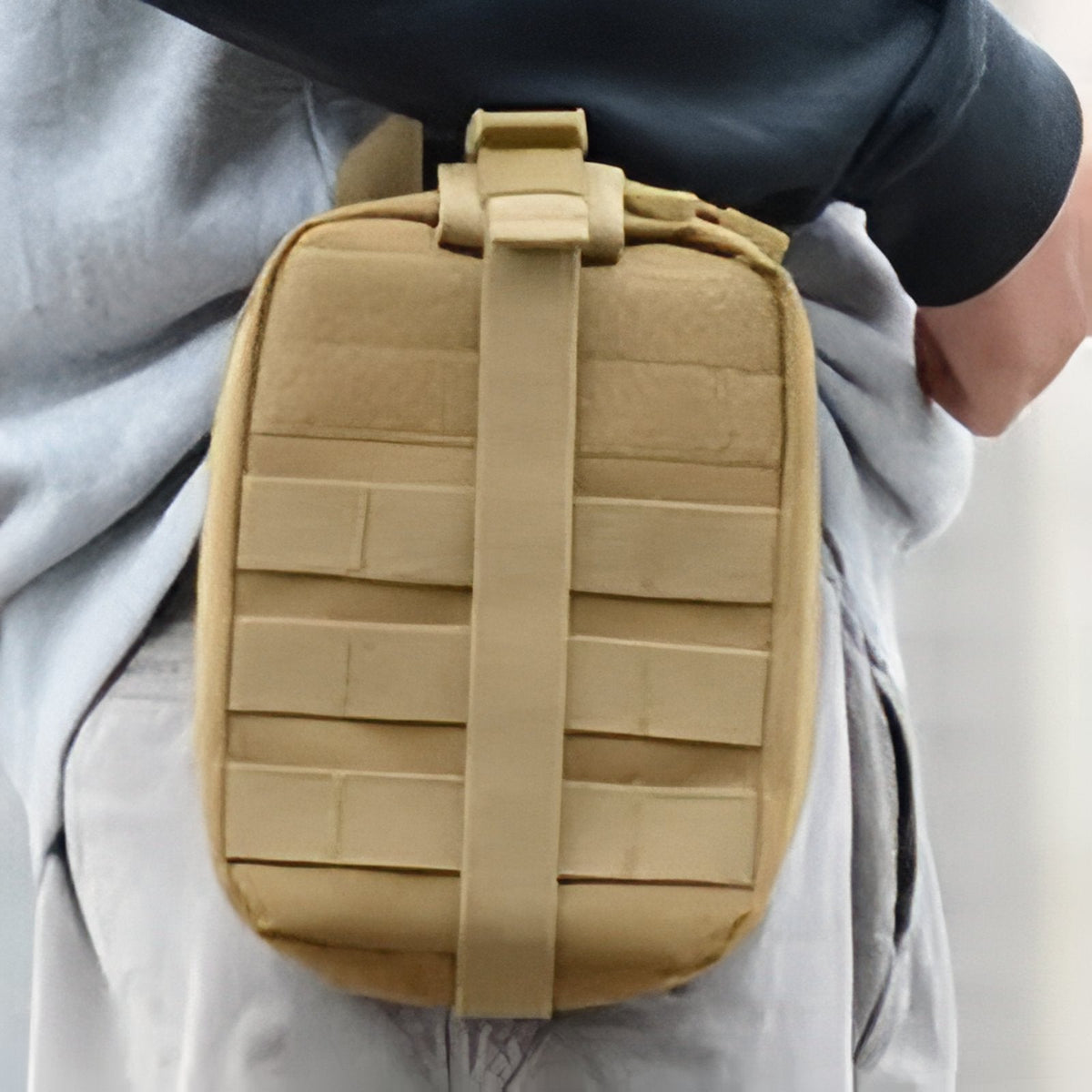 Khaki first aid pouch worn on a belt at the hip