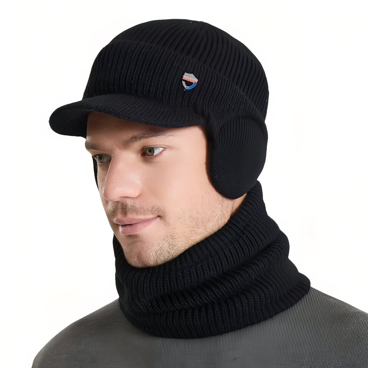 Man wearing the black knit winter hat with brim and ear flaps and the matching neck warmer
