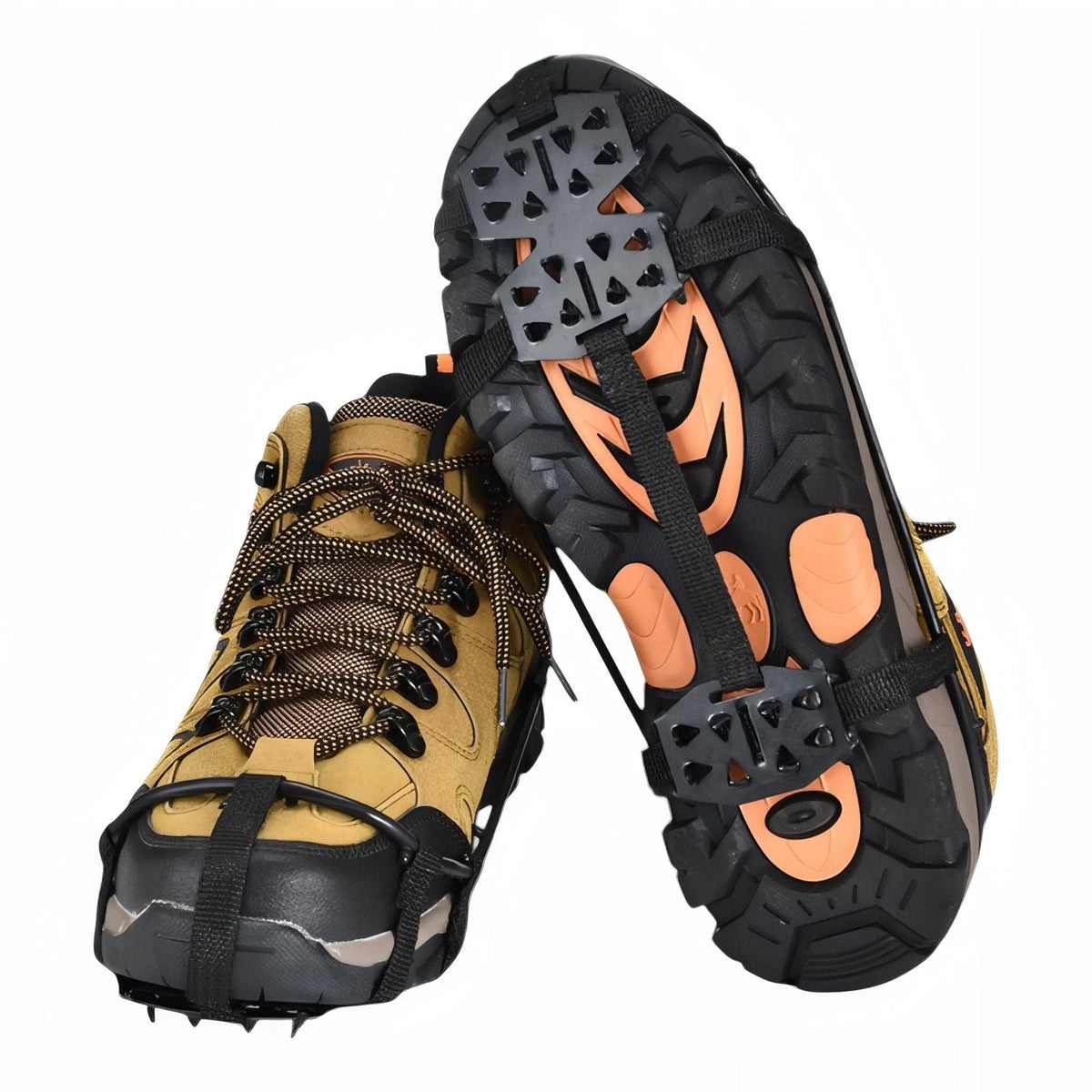 Pair of black slip-on crampons fitted to tan hiking boots, one boot tipped up to show the two spike plates and instep straps on the sole