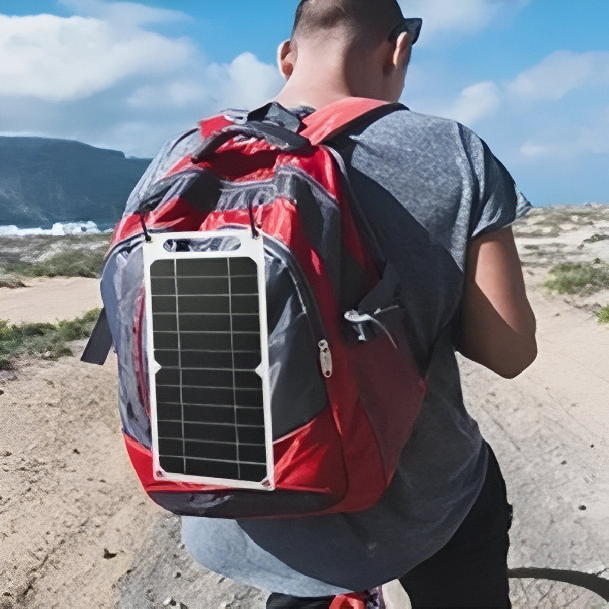 Walker with the solar panel hanging on the back of a red backpack