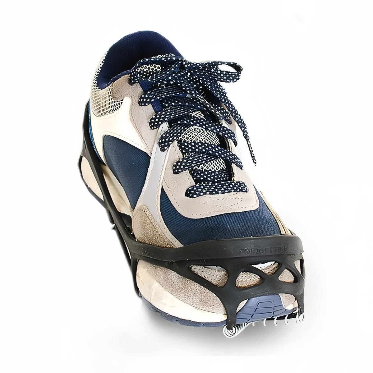 Ice grip fitted over a navy and white walking shoe, the instep strap across the top