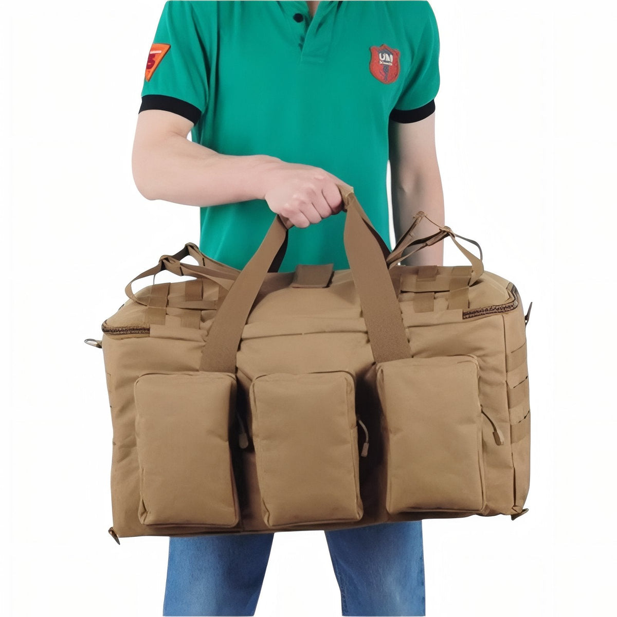 Man carrying the coyote brown duffel by its handles