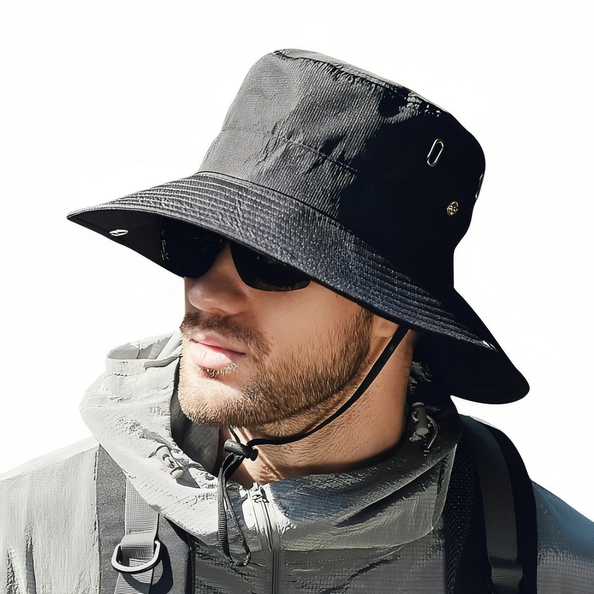 Man wearing the black wide-brim hiking hat with the chin cord fastened