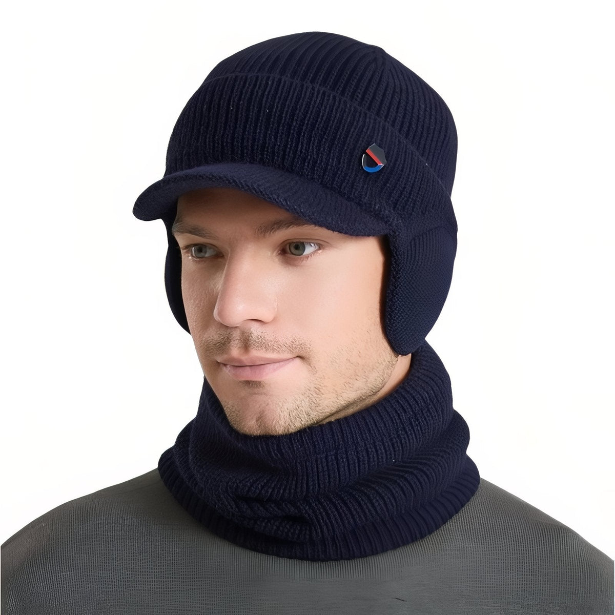 Man wearing the navy blue knit winter hat with brim and ear flaps and the matching neck warmer