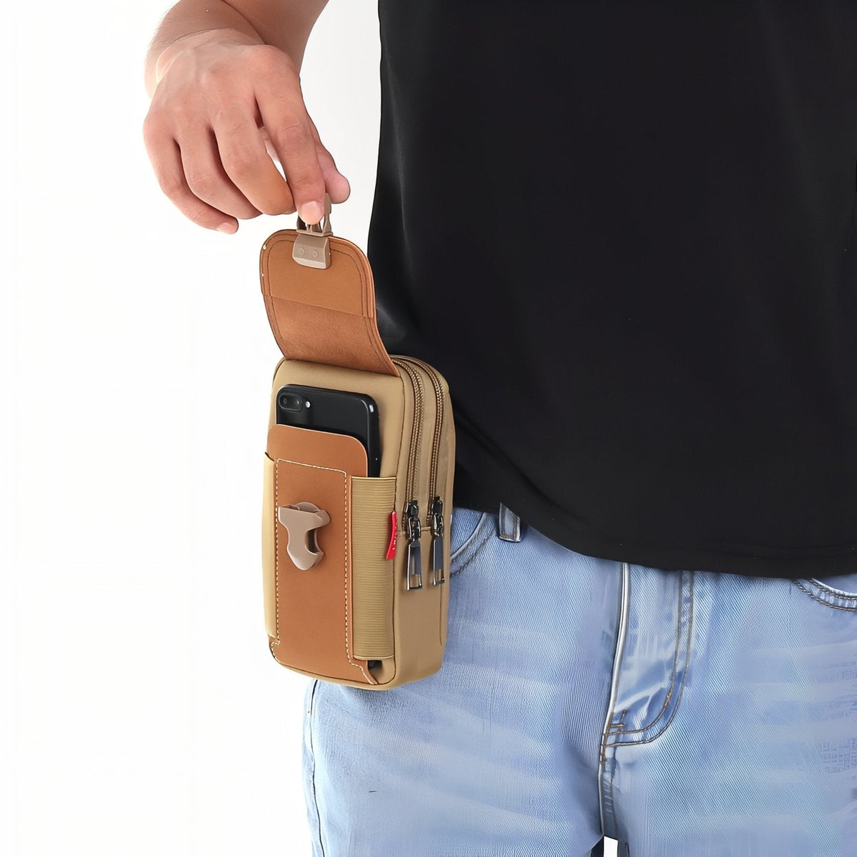 A phone being taken from the front pocket of the brown pouch worn on a belt