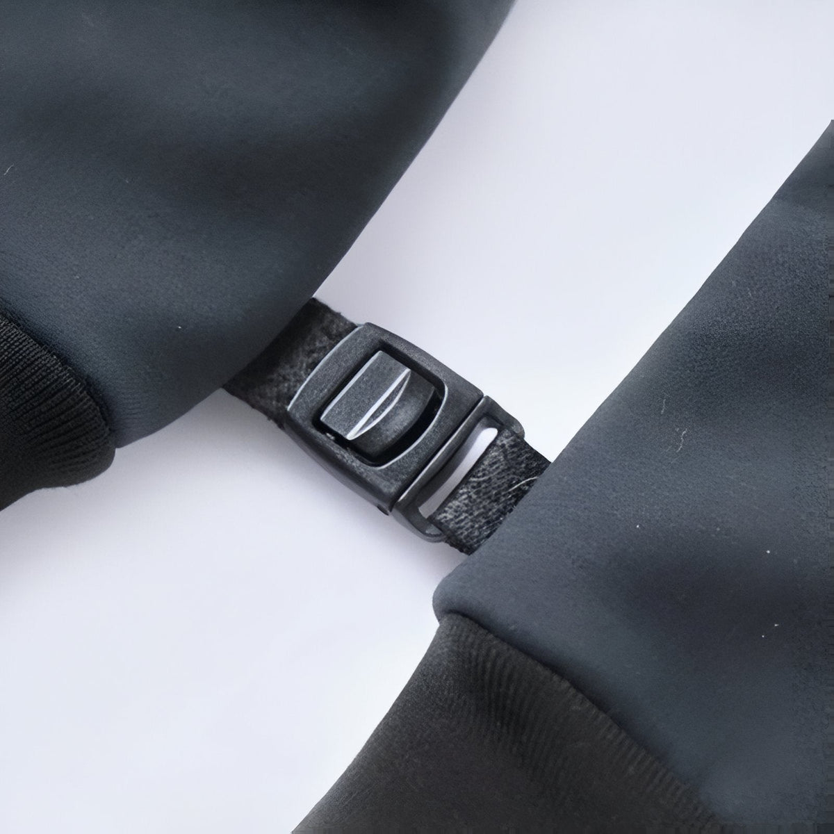 Close-up of the webbing tab and plastic buckle on the cuff of a hiking glove