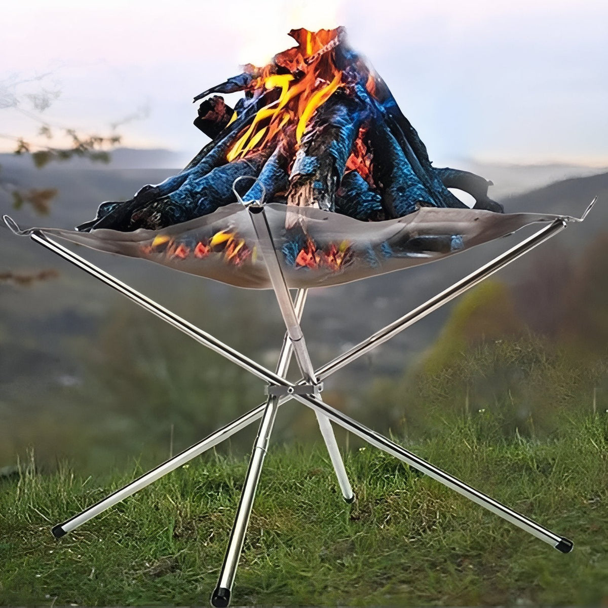 Fire pit with a wood fire on a grassy hillside