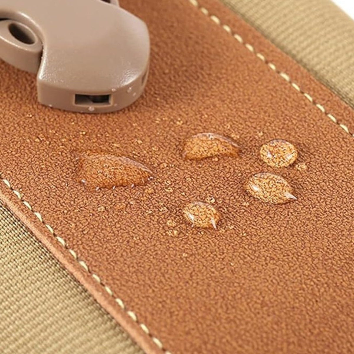 Close-up of water droplets on the brown flap beside the plastic buckle